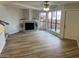 Bright living room boasts hardwood floors, a cozy fireplace, and large windows for natural light at 3228 W Glendale Ave # 103, Phoenix, AZ 85051