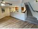 Inviting living room featuring hardwood floors and stairs leading to the next level and open kitchen at 3228 W Glendale Ave # 103, Phoenix, AZ 85051