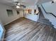 Inviting living room featuring hardwood floors, a ceiling fan, and stairs leading to the next level at 3228 W Glendale Ave # 103, Phoenix, AZ 85051