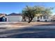 Charming single-story home featuring a well-maintained front yard with mature tree at 3415 W Orchid Ln, Phoenix, AZ 85051