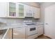 Bright kitchen features modern appliances and white cabinetry with glass-front display cabinets at 3633 N 3Rd Ave # 2016, Phoenix, AZ 85013