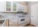 Kitchen featuring white cabinetry, marble countertops, and modern white appliances at 3633 N 3Rd Ave # 2016, Phoenix, AZ 85013