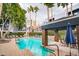 Resort-style pool area with comfortable lounge chairs, lush landscaping, and serene waterfall feature at 3633 N 3Rd Ave # 2016, Phoenix, AZ 85013