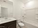 Well-lit bathroom featuring a shower-tub combo and a vanity with sink at 36986 W Prado St, Maricopa, AZ 85138