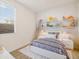 Lovely bedroom with stylish decor, cozy bedding, and a large window at 36986 W Prado St, Maricopa, AZ 85138