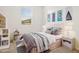 Charming bedroom with stylish decor, cozy bedding, and a large window at 36986 W Prado St, Maricopa, AZ 85138