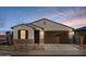 Charming single-story home with a two-car garage and low-maintenance desert landscaping at 36986 W Prado St, Maricopa, AZ 85138