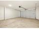 Spacious garage with a concrete floor and an automatic door at 36986 W Prado St, Maricopa, AZ 85138