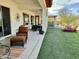 Expansive backyard featuring a covered patio, lush green lawn, and lounge chairs at 4116 E Sierra Sunset Trl, Cave Creek, AZ 85331
