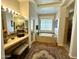 Bathroom featuring a bathtub, vanity, mirror, and decorative tiles at 4116 E Sierra Sunset Trl, Cave Creek, AZ 85331