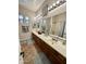 Bathroom featuring double sinks, vanity, mirror, and decorative tiles at 4116 E Sierra Sunset Trl, Cave Creek, AZ 85331