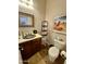 Bathroom featuring a decorative sink, toilet, and a metal rack for towels and toiletries at 4116 E Sierra Sunset Trl, Cave Creek, AZ 85331