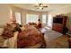 Spacious bedroom features a ceiling fan, comfortable seating area, tv and a stylish southwestern-patterned bedspread at 4116 E Sierra Sunset Trl, Cave Creek, AZ 85331
