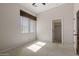 Neutral bedroom with a window, ceiling fan, carpeted floors, and closet at 4116 E Sierra Sunset Trl, Cave Creek, AZ 85331