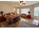 Spacious bedroom features a ceiling fan, comfortable seating area and a stylish southwestern-patterned bedspread at 4116 E Sierra Sunset Trl, Cave Creek, AZ 85331