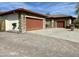 Paved driveway leads to a residence with a stone exterior, multi-car garage, and neat landscaping at 4116 E Sierra Sunset Trl, Cave Creek, AZ 85331