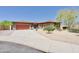 Charming single-story home featuring a well-manicured desert landscape, a spacious driveway, and a two-car garage at 4116 E Sierra Sunset Trl, Cave Creek, AZ 85331