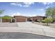 Charming single-story home featuring a tile roof, brick accents, and a three-car garage at 4116 E Sierra Sunset Trl, Cave Creek, AZ 85331