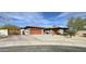 Charming home with stone accents, a tile roof, wooden gate, and a spacious driveway at 4116 E Sierra Sunset Trl, Cave Creek, AZ 85331