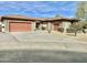 Beautiful single-story home with stone accents, a tile roof, a multi-car garage, and mature landscaping at 4116 E Sierra Sunset Trl, Cave Creek, AZ 85331
