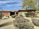 Attractive landscaping complements the stone exterior of this single-story home with mature desert landscaping at 4116 E Sierra Sunset Trl, Cave Creek, AZ 85331