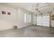 Spacious garage with an automatic door, concrete flooring, and ample lighting from the windows at 4116 E Sierra Sunset Trl, Cave Creek, AZ 85331