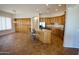 Spacious kitchen featuring an island with seating, wooden cabinets, tile floors, and ample natural light at 4116 E Sierra Sunset Trl, Cave Creek, AZ 85331