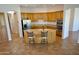Open kitchen showcases a large island, wooden cabinets, stainless steel appliances, and tile flooring at 4116 E Sierra Sunset Trl, Cave Creek, AZ 85331