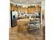 Well-lit kitchen features a center island with seating, custom cabinetry, and stainless steel appliances at 4116 E Sierra Sunset Trl, Cave Creek, AZ 85331