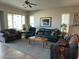 Spacious living room with carpet, couches, ceiling fan, and large windows overlooking the outside area at 4116 E Sierra Sunset Trl, Cave Creek, AZ 85331