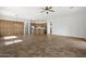 Open living space with neutral paint, ceiling fan, tile floors, and kitchen access at 4116 E Sierra Sunset Trl, Cave Creek, AZ 85331