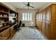 Office features a large desk, cabinets, and a ceiling fan at 4116 E Sierra Sunset Trl, Cave Creek, AZ 85331