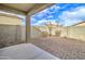 Backyard area with a low-maintenance gravel landscape and covered patio at 4240 W Crossflower Ave, San Tan Valley, AZ 85144