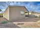 Exterior side view of backyard with gravel landscaping and covered patio at 4240 W Crossflower Ave, San Tan Valley, AZ 85144