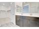 Bathroom with double vanity, large mirrors, and an adjacent walk-in closet at 4240 W Crossflower Ave, San Tan Valley, AZ 85144