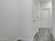 Hallway of home with many white doors and wood floors at 4240 W Crossflower Ave, San Tan Valley, AZ 85144