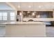 Bright kitchen with a large center island, granite countertops, and stainless steel appliances at 4240 W Crossflower Ave, San Tan Valley, AZ 85144