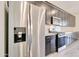 Modern kitchen featuring stainless steel refrigerator, microwave, and dark cabinetry at 4240 W Crossflower Ave, San Tan Valley, AZ 85144