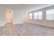 Bright living room featuring vinyl flooring, white walls and multiple windows for natural light at 4240 W Crossflower Ave, San Tan Valley, AZ 85144