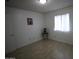 Cozy bedroom with natural light from a large window, neutral paint, and tile flooring at 4409 E Wood St, Phoenix, AZ 85040