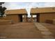 Welcoming community entrance showing sidewalk pavers leading to openings and wrought iron fencing beyond at 4409 E Wood St, Phoenix, AZ 85040