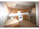 Traditional kitchen with wood cabinets, tiled floor, and stainless steel refrigerator at 4409 E Wood St, Phoenix, AZ 85040