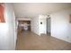 Open-plan living room with tile floors leading to the kitchen at 4409 E Wood St, Phoenix, AZ 85040