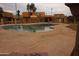Relaxing community pool highlighted by ample deck space and surrounded by lush landscaping and residential buildings at 4409 E Wood St, Phoenix, AZ 85040
