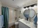 Bathroom with updated vanity, lighting fixtures, and shower-tub combo at 4524 W Larkspur Dr, Glendale, AZ 85304