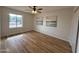 Comfortable bedroom with wood floors, ceiling fan, and bright natural light at 4524 W Larkspur Dr, Glendale, AZ 85304