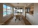 Dining area with a round table, chairs, large windows, and a view of the pool at 4524 W Larkspur Dr, Glendale, AZ 85304