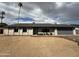 Frontal view of a well-maintained single-story home with grey brick and desert yard at 4524 W Larkspur Dr, Glendale, AZ 85304