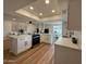 Bright kitchen with white cabinets, island, stainless steel appliances, and hardwood floors at 4524 W Larkspur Dr, Glendale, AZ 85304