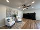 Cozy living room with hardwood floors, fireplace, and two armchairs at 4524 W Larkspur Dr, Glendale, AZ 85304